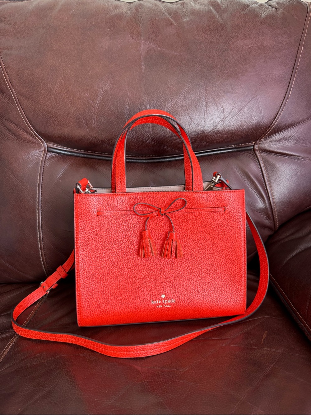 Kate Spade Red-Orange Pebbled Leather Satchel with Tassel Bow